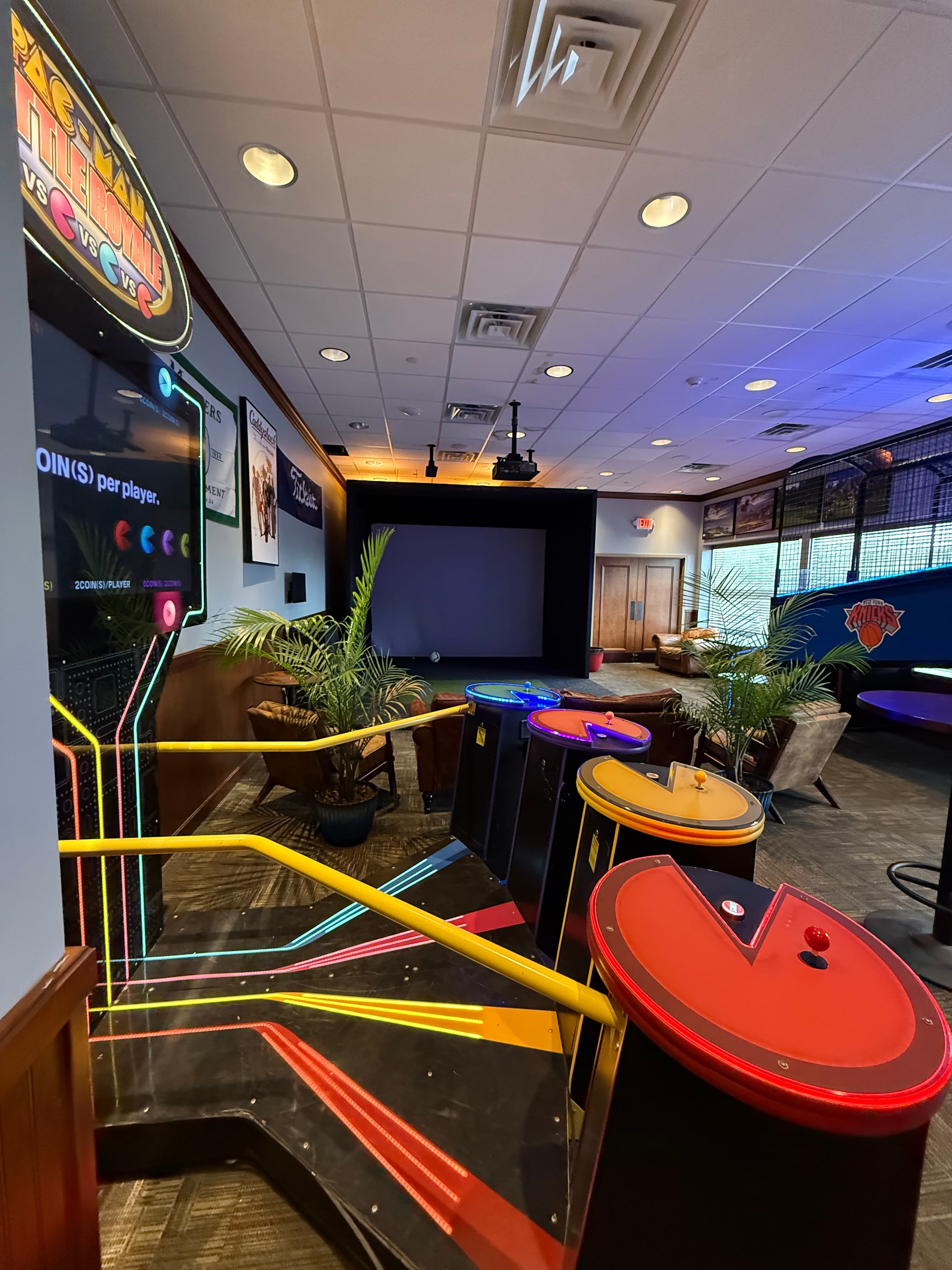 Colorful arcade games and air hockey tables in entertainment area